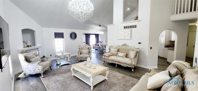 2249 Woods Edge Ct, Toledo, OH 43615 - living room with arched walkways, high vaulted ceiling, and wood finished floors