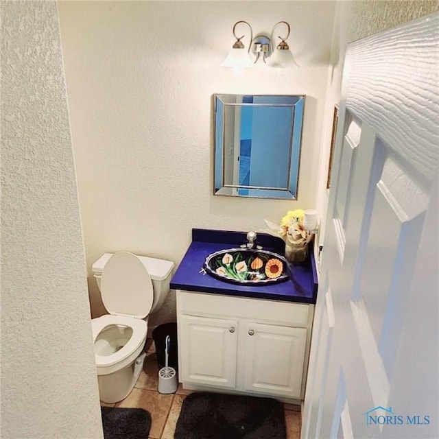 2249 Woods Edge Ct, Toledo, OH 43615 - bathroom with vanity, toilet, and a textured wall