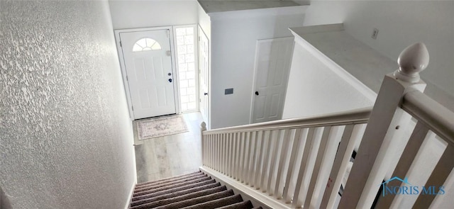 2249 Woods Edge Ct, Toledo, OH 43615 - entrance foyer with stairway, wood finished floors, and a textured wall