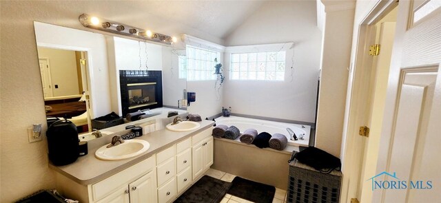 2249 Woods Edge Ct, Toledo, OH 43615 - full bathroom featuring a bath, double vanity, lofted ceiling, and a sink