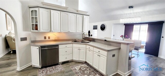 2249 Woods Edge Ct, Toledo, OH 43615 - kitchen featuring white cabinetry, a peninsula, a sink, glass insert cabinets, and stainless steel dishwasher