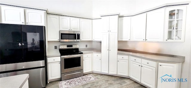 2249 Woods Edge Ct, Toledo, OH 43615 - kitchen with appliances with stainless steel finishes, white cabinets, and light countertops
