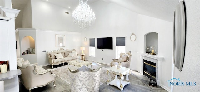 2249 Woods Edge Ct, Toledo, OH 43615 - living area featuring baseboards, visible vents, high vaulted ceiling, a premium fireplace, and an inviting chandelier