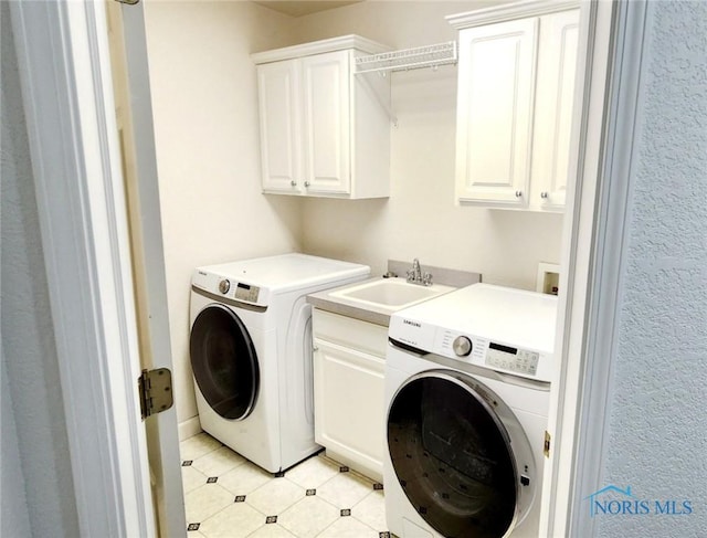 2249 Woods Edge Ct, Toledo, OH 43615 - laundry room featuring washing machine and clothes dryer, cabinet space, and a sink
