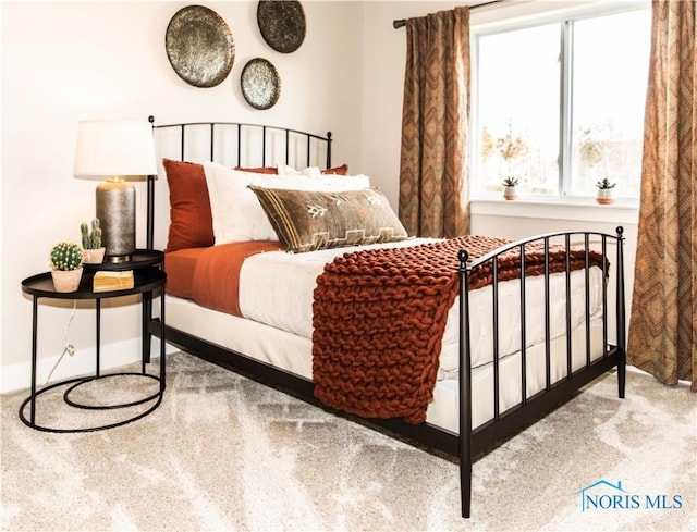 bedroom featuring baseboards and carpet floors