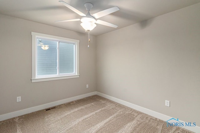 unfurnished room featuring light carpet, visible vents, baseboards, and ceiling fan
