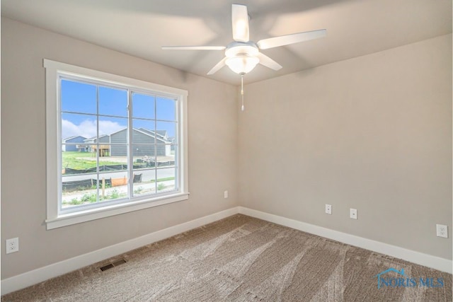 unfurnished room with visible vents, baseboards, ceiling fan, and carpet flooring