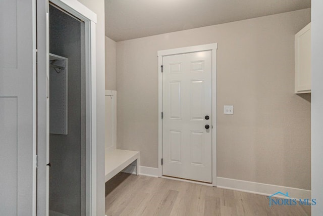 mudroom featuring light wood-style flooring and baseboards
