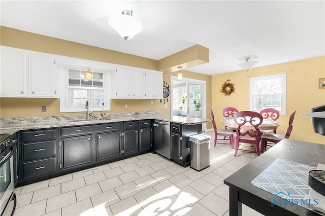 10132 Laplante Rd, Monclova, OH 43542 - kitchen featuring appliances with stainless steel finishes, dark cabinets, white cabinetry, and plenty of natural light