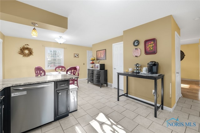 10132 Laplante Rd, Monclova, OH 43542 - kitchen featuring stainless steel dishwasher, light tile patterned floors, dark cabinetry, and light stone countertops