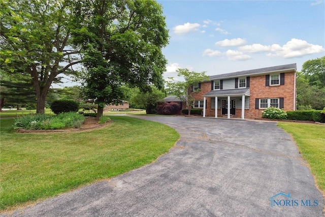10132 Laplante Rd, Monclova, OH 43542 - view of front of property featuring brick siding, driveway, and a front lawn