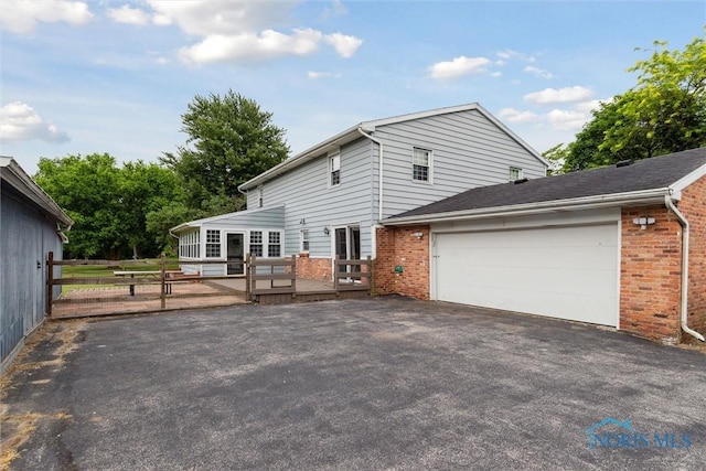 10132 Laplante Rd, Monclova, OH 43542 - view of front of house with driveway, brick siding, a garage, and a deck
