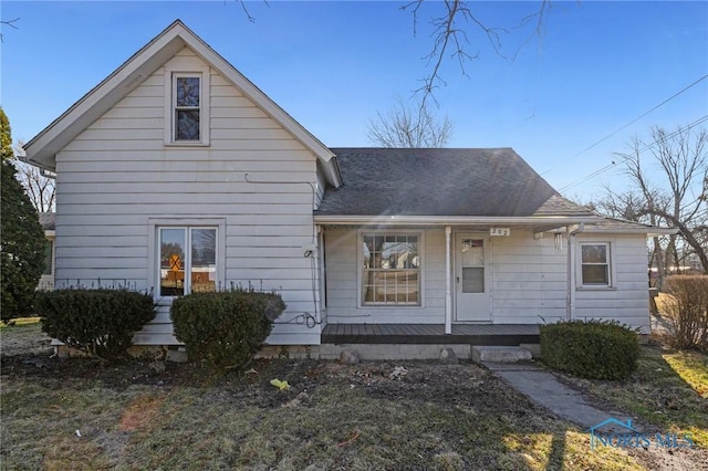 view of front of house featuring covered porch and a shingled roof
