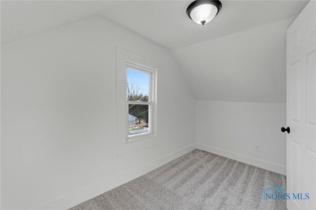 bonus room with lofted ceiling, carpet flooring, and baseboards