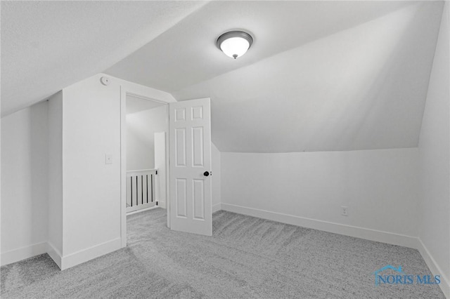 bonus room featuring lofted ceiling, baseboards, and carpet floors