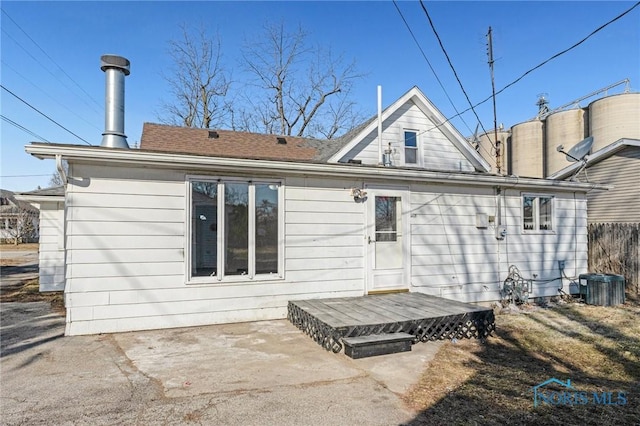 back of house featuring a patio area, fence, and central AC