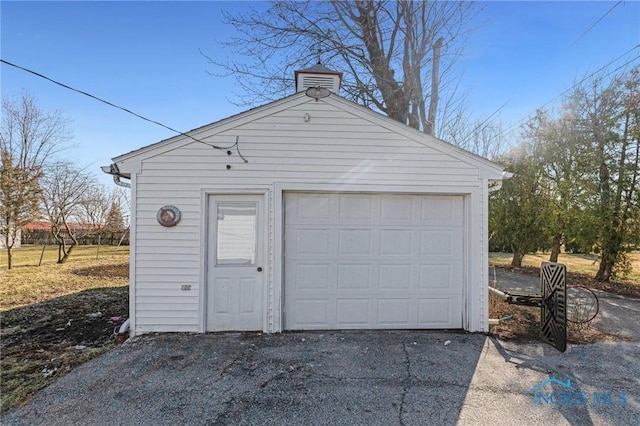 detached garage featuring driveway