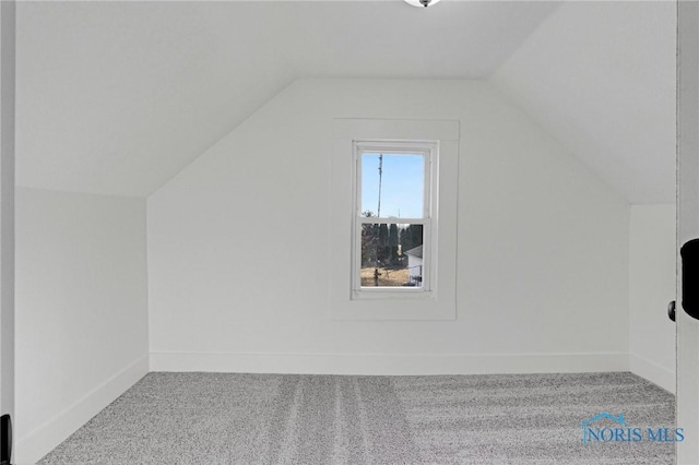 bonus room with baseboards, lofted ceiling, and carpet floors