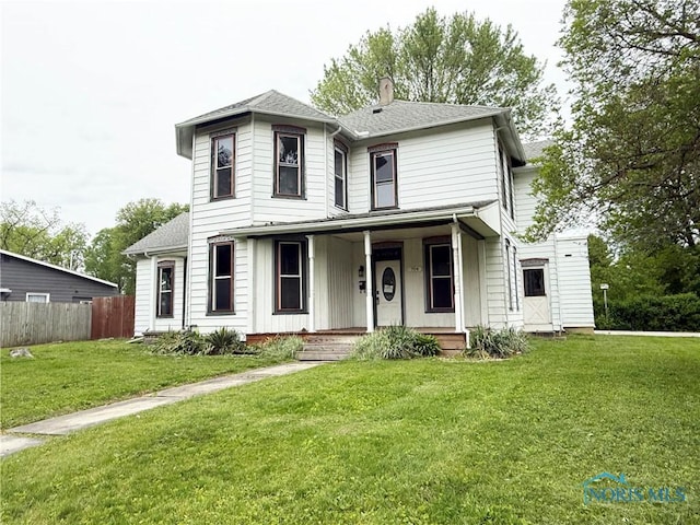 704 W Fremont St, Fostoria, OH 44830 - view of front of house with covered porch and a chimney