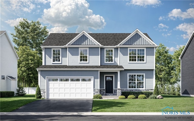 view of front of house featuring driveway, a front yard, board and batten siding, and an attached garage