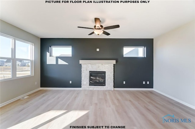 unfurnished living room with a ceiling fan, wood finished floors, baseboards, visible vents, and a stone fireplace