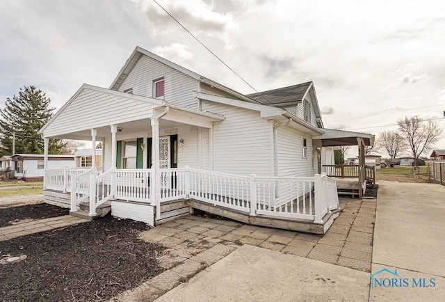 view of property exterior featuring covered porch