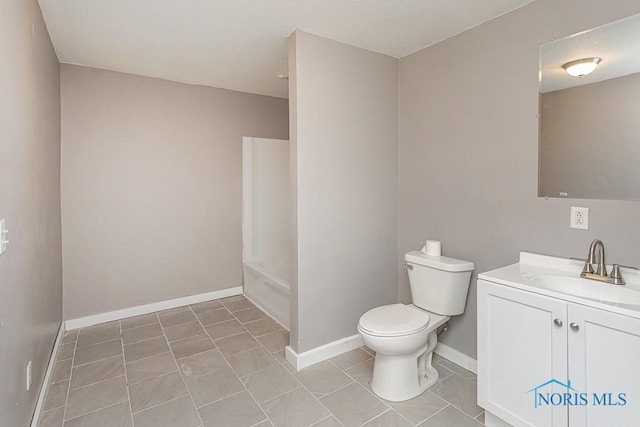 full bath with tile patterned floors, toilet, vanity, baseboards, and shower / bath combination