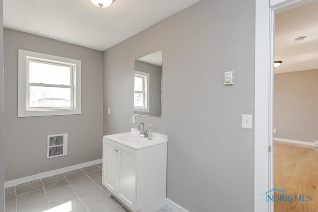 bathroom with baseboards and vanity