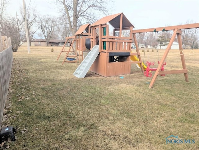 view of playground featuring a lawn and fence