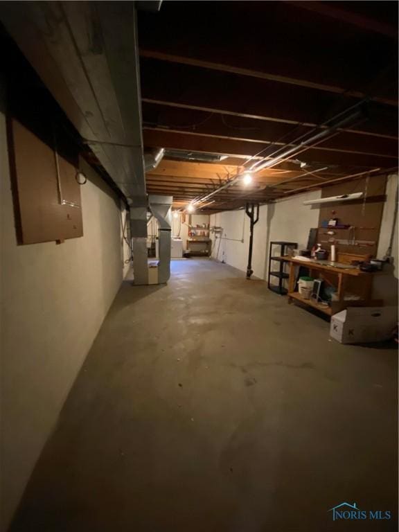 unfinished below grade area featuring heating unit