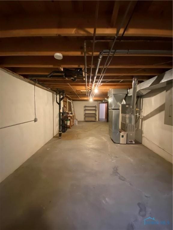 unfinished below grade area featuring heating unit