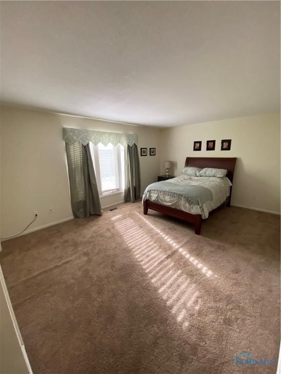 bedroom with carpet floors and baseboards