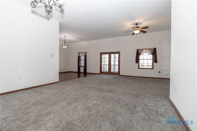 2121 County Road 4 Unit 1, Swanton, OH 43558 - unfurnished living room with ceiling fan with notable chandelier, visible vents, carpet floors, and baseboards