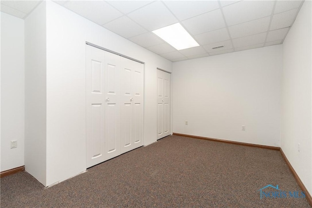 2121 County Road 4 Unit 1, Swanton, OH 43558 - unfurnished bedroom with a paneled ceiling, carpet floors, two closets, and visible vents
