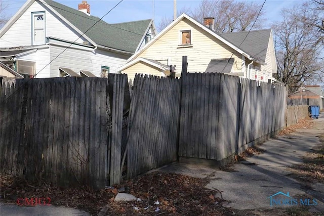 1142 Page St, Toledo, OH 43608 - view of home's exterior with fence and a chimney