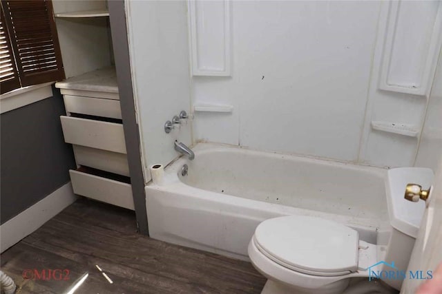 1142 Page St, Toledo, OH 43608 - bathroom featuring wood finished floors, toilet, and bathtub / shower combination