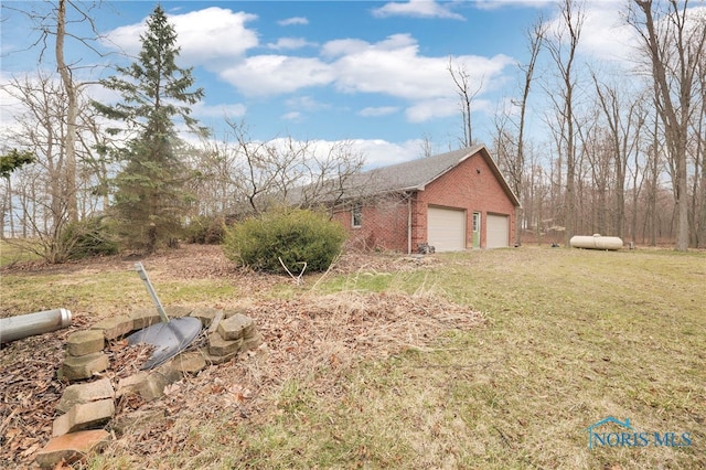 view of side of home featuring a yard and brick siding