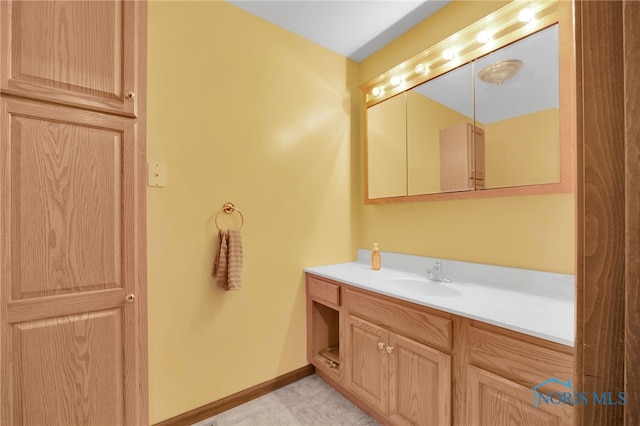 bathroom with vanity and baseboards