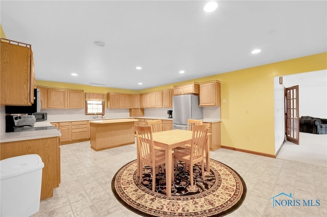 dining space with recessed lighting, baseboards, and light floors