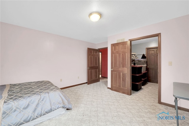carpeted bedroom featuring visible vents and baseboards