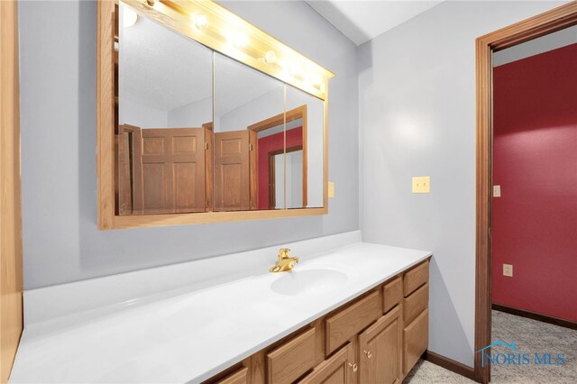 bathroom featuring vanity and baseboards