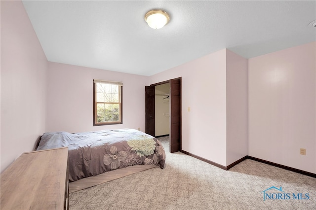 carpeted bedroom featuring baseboards