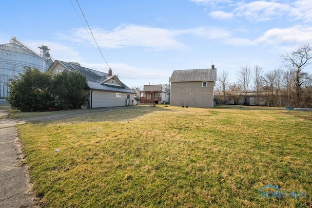 view of yard with an outbuilding and a storage shed