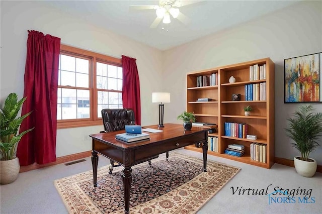 carpeted home office with baseboards, visible vents, and a ceiling fan