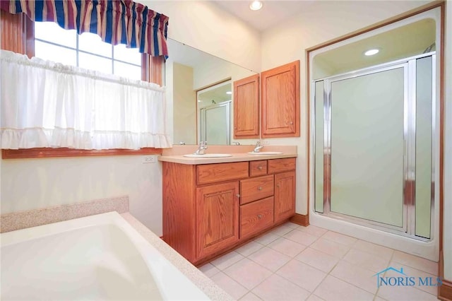 full bathroom featuring a bath, double vanity, tile patterned floors, a sink, and a stall shower