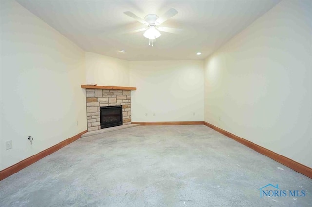 unfurnished living room with baseboards, a fireplace, carpet flooring, and a ceiling fan