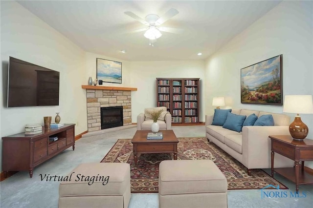 carpeted living area featuring ceiling fan and a stone fireplace