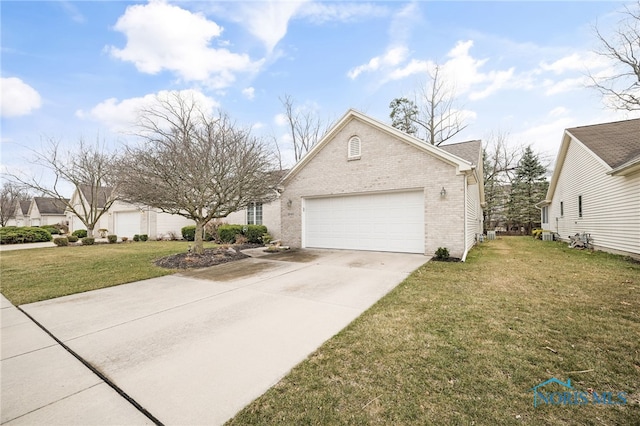 view of front of home with driveway, brick siding, a garage, and a front lawn