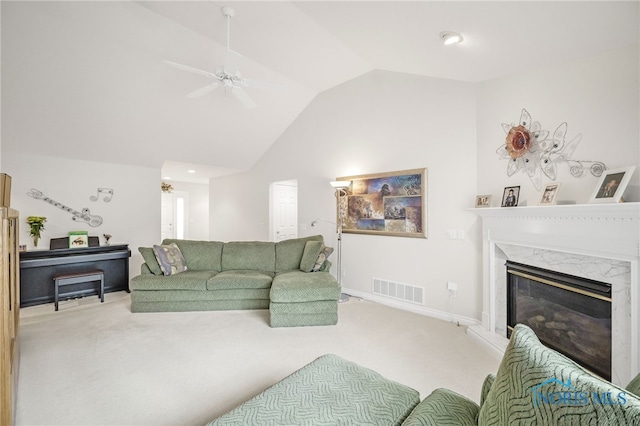 carpeted living area featuring visible vents, ceiling fan, a premium fireplace, and vaulted ceiling