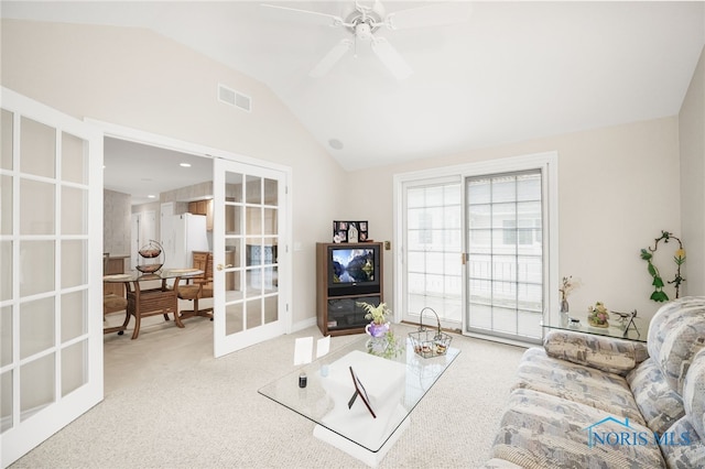 carpeted living room featuring lofted ceiling, ceiling fan, visible vents, and french doors